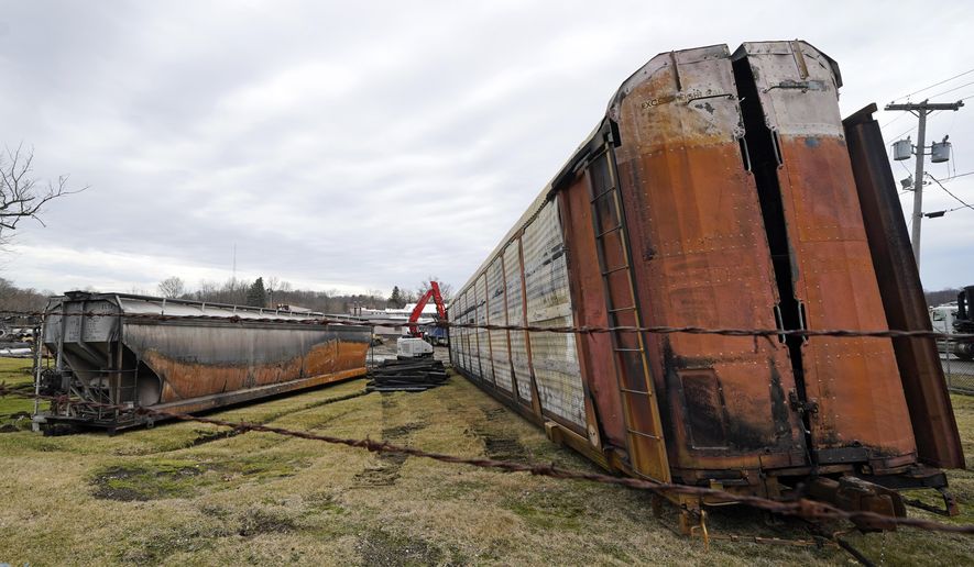 Some of the railcars that derailed Friday night when a Norfolk Southern freight train derailed are in the process of being cleaned up on Thursday, Feb. 9, 2023 in East Palestine, Ohio.(AP Photo/Gene J. Puskar)