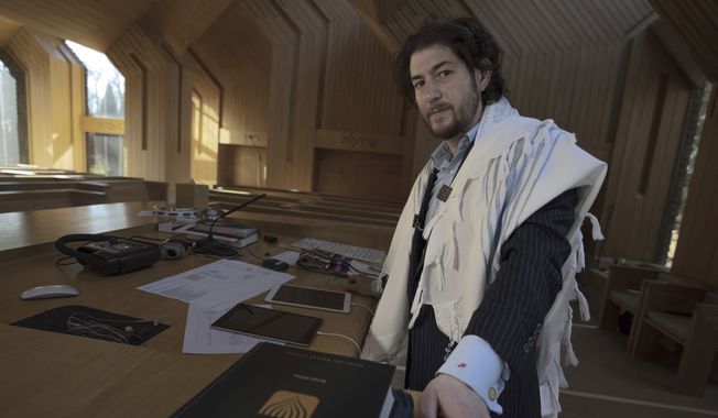 Rabbi Joshua Franklin stands inside the sanctuary at the Jewish Center of the Hamptons in East Hampton, New York on Feb. 10, 2023. Franklin expermented writing a sermon for his congregation using artificial intelligence software Chat GPT, and concluded that AI can&#x27;t replace the work of human faith leaders. (AP Photo/Robert Bumsted)