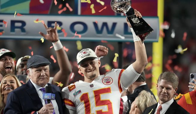 Kansas City Chiefs quarterback Patrick Mahomes (15) holds the Vince Lombardi Trophy next to Terry Bradshaw, left, and Chiefs owner Clark Hunt after the NFL Super Bowl 57 football game against the Philadelphia Eagles, Sunday, Feb. 12, 2023, in Glendale, Ariz. The Kansas City Chiefs defeated the Philadelphia Eagles 38-35. (AP Photo/Marcio J. Sanchez)