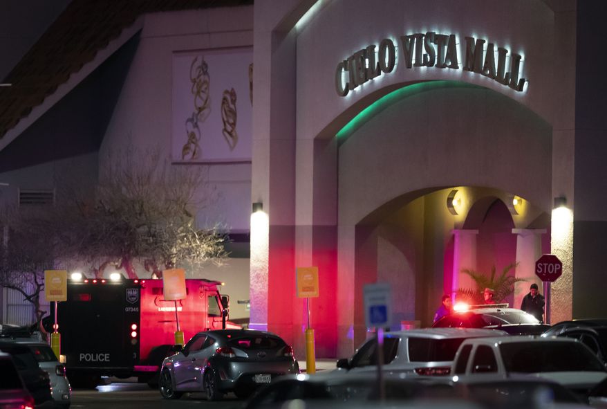 Law enforcement agents are seen at an entrance of a shopping mall, Wednesday, Feb. 15, 2023, in El Paso, Texas. Police say one person was killed and three other people were wounded in a shooting at Cielo Vista Mall. (AP Photo/Andrés Leighton)