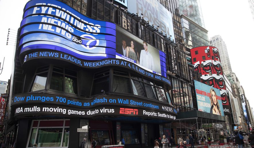 An electronic ticker displays news Wednesday, March 11, 2020, in New York's Times Square. A new survey released Wednesday, Feb. 15, 2023, shows fully half of Americans indicate they believe national news organizations intend to mislead, misinform or persuade the public to adopt a point of view. (AP Photo/Mary Altaffer, File)
