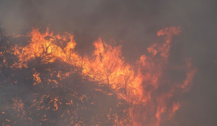 The Fairview Fire burns on a hillside Thursday, Sept. 8, 2022, near Hemet, Calif. (AP Photo/Ringo H.W. Chiu)