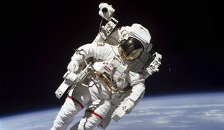 This Feb. 7, 1984 photo made available by NASA shows astronaut Bruce McCandless II, participating in a spacewalk a few meters away from the cabin of the Earth-orbiting space shuttle Challenger, using a nitrogen-propelled Manned Maneuvering Unit. The Johnson Space Center says McCandless died Thursday, Dec. 21, 2017 in California. (NASA via AP)