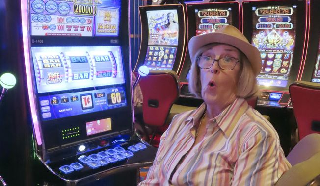 A gambler reacts to a slot machine result at the Hard Rock casino in Atlantic City N.J., on Aug. 8, 2022. New Jersey gambling regulators released figures, Thursday, Feb. 16, 2023, showing Atlantic City&#x27;s casinos won $211.6 million from in-person gamblers in January, up 15.3% from a year ago. When revenue from internet gambling and sports betting is included, the casinos, horse tracks that take sports bets, and the online partners of both of those businesses won $436.8 million, up 14.5% from a year ago. (AP Photo/Wayne Parry)