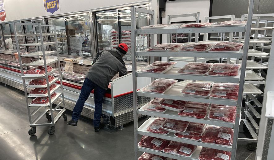 An employee restocks meats at a grocery store on Tuesday, Jan. 17, 2023, in North Miami, Fla. (AP Photo/Wilfredo Lee) ** FILE **