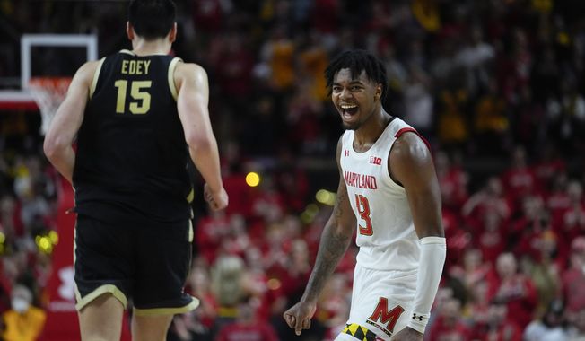 Maryland guard Hakim Hart (13) reacts after a basket as Purdue center Zach Edey (15) runs by during the second half of an NCAA college basketball game, Thursday, Feb. 16, 2023, in College Park, Md. Maryland won 68-54. (AP Photo/Julio Cortez)