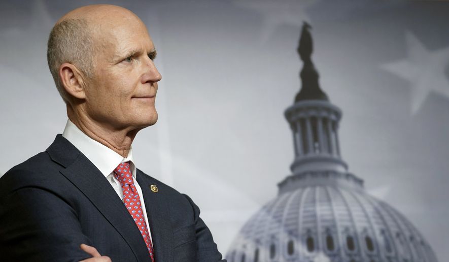 Sen. Rick Scott, R-Fla., listens during a news conference on the budget bill, Dec. 20, 2022, on Capitol Hill in Washington. Scott has amended a plan to overhaul how the federal government works after Democrats repeatedly seized on it to accuse Republicans of looking to cut Medicare and Social Security. (AP Photo/Mariam Zuhaib, File)
