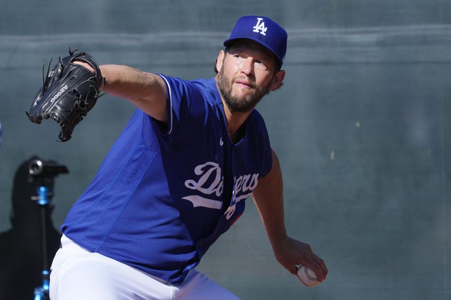 Los Angeles Dodgers starting pitcher Clayton Kershaw throws during the first day of spring training baseball workouts for Dodgers pitchers and catchers in Phoenix, Thursday, Feb. 16, 2023. (AP Photo/Ross D. Franklin)