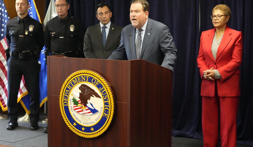Jeffrey Abrams, Regional Director of Anti-Defamation League, ADL Los Angeles, at podium, denounces anti-Semitism and hate crimes at a news conference at the U.S. Attorney's Office Central District of California offices in Los Angeles Friday, Feb. 17, 2023. From left, United States Attorney Martin Estrada and Los Angeles Mayor Karen Bass. A person was taken into custody Thursday in connection with the shootings of two Jewish men outside synagogues in Los Angeles this week that investigators believe were hate crimes, police said. (AP Photo/Damian Dovarganes)