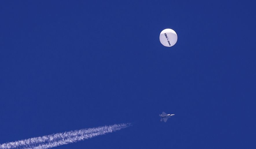 In this photo provided by Chad Fish, a large balloon drifts above the Atlantic Ocean, just off the coast of South Carolina, with a fighter jet and its contrail seen below it, Saturday, Feb. 4, 2023. U.S. officials say the military has finished efforts to recover the remnants of the large balloon that was shot down off the coast of South Carolina, and analysis of the debris so far reinforces conclusions that it was a Chinese spy balloon.  (Chad Fish via AP, File)