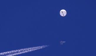 In this photo provided by Chad Fish, a large balloon drifts above the Atlantic Ocean, just off the coast of South Carolina, with a fighter jet and its contrail seen below it, Saturday, Feb. 4, 2023. U.S. officials say the military has finished efforts to recover the remnants of the large balloon that was shot down off the coast of South Carolina, and analysis of the debris so far reinforces conclusions that it was a Chinese spy balloon. (Chad Fish via AP, File)
