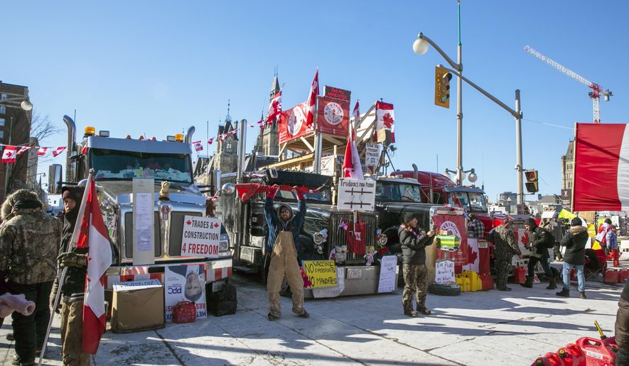 Drivers parked their trucks blocking lanes of traffic to protest against pandemic restrictions in Ottawa, Ontario, on Monday, Feb. 14, 2022. A public commission announced Friday, Feb. 17, 2023, that Canadian Prime Minister Justin Trudeau’s government met the “very high threshold” for invoking the Emergencies Act to quell the protests by truckers and others angry over Canada’s COVID-19 restrictions last winter. (AP Photo/Ted Shaffrey, File)