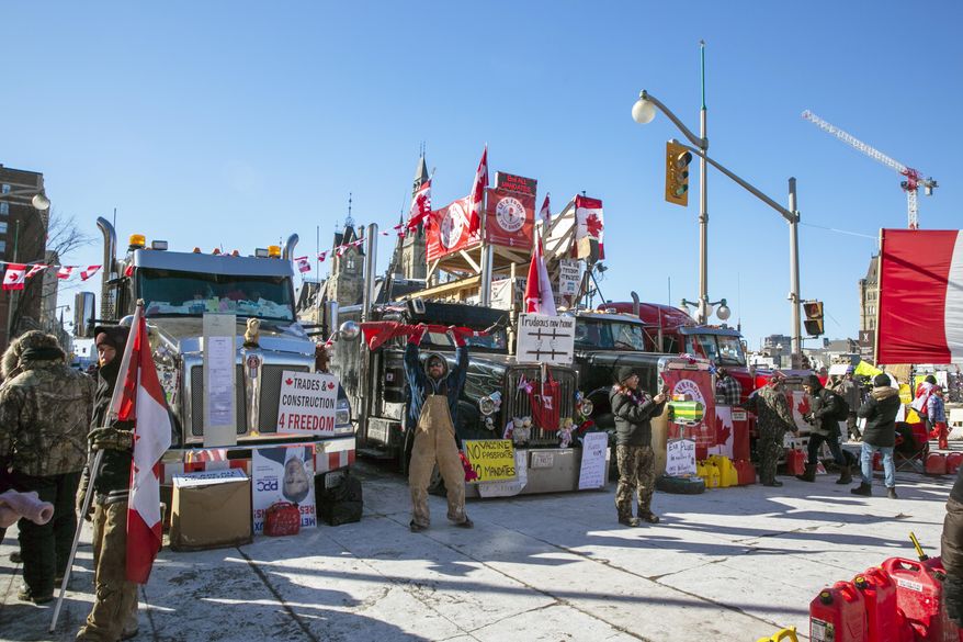 Drivers parked their trucks blocking lanes of traffic to protest against pandemic restrictions in Ottawa, Ontario, on Monday, Feb. 14, 2022. A public commission announced Friday, Feb. 17, 2023, that Canadian Prime Minister Justin Trudeau’s government met the “very high threshold” for invoking the Emergencies Act to quell the protests by truckers and others angry over Canada’s COVID-19 restrictions last winter. (AP Photo/Ted Shaffrey, File)