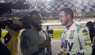 Josh Sims, left, of FOX Sports interviews Alex Bowman after he qualified for the pole position in the NASCAR Daytona 500 auto race at Daytona International Speedway, Wednesday, Feb. 15, 2023, in Daytona Beach, Fla. (AP Photo/John Raoux)