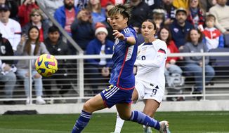 U.S. forward Mallory Swanson, right, kicks the ball past Japan defender Moeka Minami during the first half of a SheBelieves Cup soccer match Sunday, Feb. 19, 2023, in Nashville, Tenn. (AP Photo/Mark Zaleski)