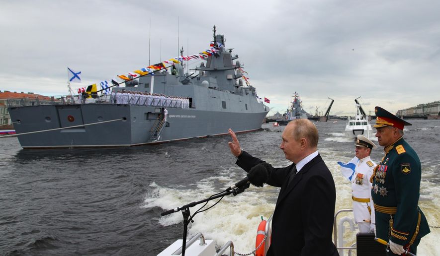 Russian President Vladimir Putin, center, and Russian Defense Minister Sergei Shoigu, right, review warships before the main naval parade marking Russian Navy Day in the Gulf of Finland, St. Petersburg, Russia, Sunday, July 31, 2022. (Mikhail Klimentyev, Sputnik, Kremlin Pool Photo via AP, File)