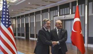 U.S. Secretary of State Antony Blinken, left, shakes hands with Turkish Foreign Minister Mevlut Cavusoglu before their meeting in Ankara, Turkey, Monday, Feb. 20, 2023. (AP Photo/Burhan Ozbilici)