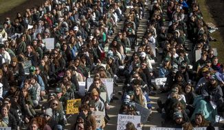 More than 1,000 Michigan State University students and concerned Michigan residents joined a sit-in protest on Monday, Feb. 20, 2023, at the Capitol in Lansing, Mich., one week after a gunman killed three students and injured five others. (Jake May/The Flint Journal via AP)
