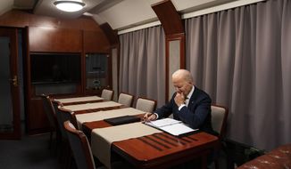 President Joe Biden sits on a train as he goes over his speech marking the one-year anniversary of the war in Ukraine after a surprise visit with Ukrainian President Volodymyr Zelenskyy, Monday, Feb. 20, 2023, in Kyiv. (AP Photo/ Evan Vucci, Pool)