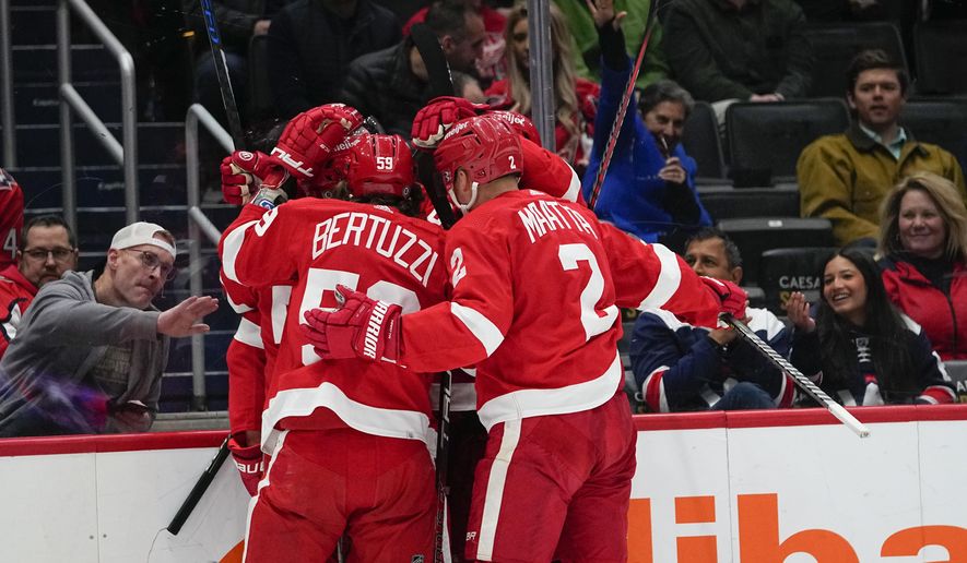 Detroit Red Wings players celebrate a goal by Robert Hagg (38) during the first period of an NHL hockey game against the Washington Capitals, Tuesday, Feb. 21, 2023, in Washington. (AP Photo/Julio Cortez)