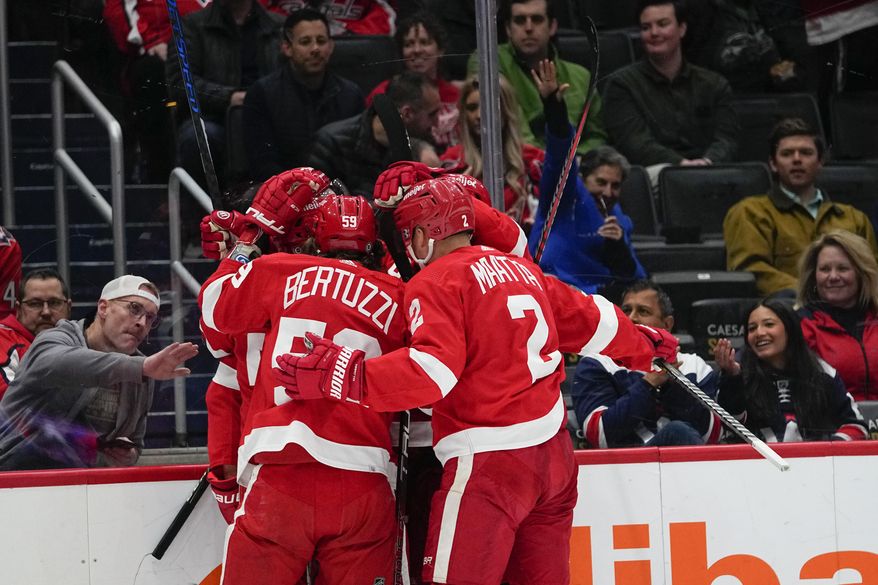 Detroit Red Wings players celebrate a goal by Robert Hagg (38) during the first period of an NHL hockey game against the Washington Capitals, Tuesday, Feb. 21, 2023, in Washington. (AP Photo/Julio Cortez)