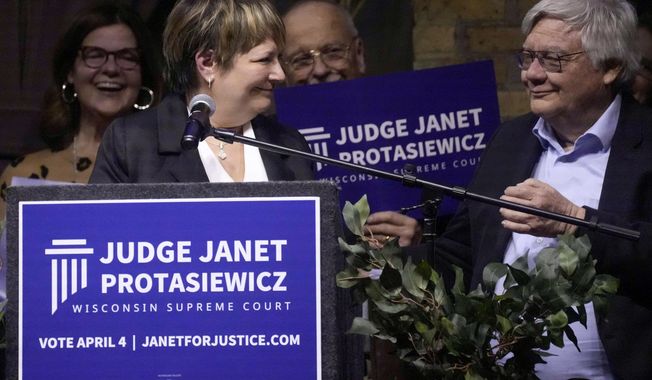 Judge Janet Protasiewicz and her husband Randy Nass share a moment during her election night party as she advances as a candidate in the April 4 election for Wisconsin Supreme Court Tuesday, Feb. 21, 2023, at Cooperage in Milwaukee. (Ebony Cox/Milwaukee Journal-Sentinel via AP)