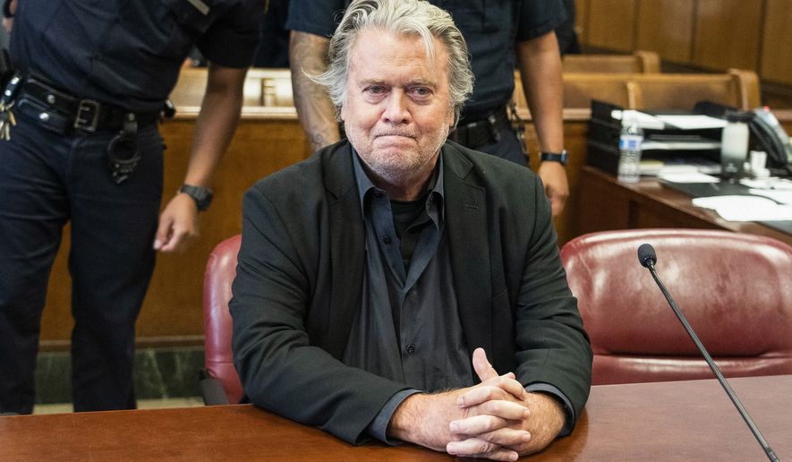 Former White House strategist Steve Bannon waits for his arraignment in Manhattan State Supreme Court after surrendering to authorities on Sept. 8, 2022, in New York. Bannon, a conservative strategist and longtime ally of former President Donald Trump, was sued for breach of contract Friday, Feb. 17, 2023, by a Manhattan law firm that defended him in several recent high-profile legal battles. (Steven Hirsch/New York Post via AP, Pool, File)