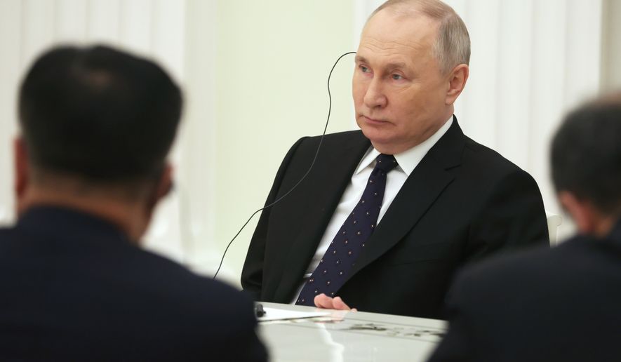 Russian President Vladimir Putin, center, listens to the Chinese Communist Party&#x27;s foreign policy chief Wang Yi during their meeting at the Kremlin in Moscow, Russia, Wednesday, Feb. 22, 2023. (Anton Novoderezhkin, Sputnik, Kremlin Pool Photo via AP)