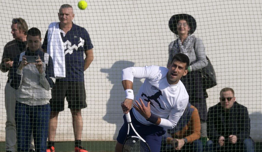 Serbian tennis player Novak Djokovic serves the ball during his open practice session in Belgrade, Serbia, Wednesday, Feb. 22, 2023. Djokovic said Wednesday he still hopes US border authorities would allow him entry to take part in two ATP Masters tennis tournaments despite being unvaccinated against the coronavirus. (AP Photo/Darko Vojinovic)