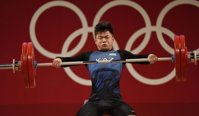 Igor Son of Kazakhstan competes in the men&#x27;s 61kg weightlifting event, at the 2020 Summer Olympics, on July 25, 2021, in Tokyo, Japan. The Weightlifting Federation of the Republic of Kazakhstan (WFRK) said Wednesday, Feb. 22, 2023, that Igor Son, who won the bronze in the men&#x27;s 61-kilogram category in Tokyo, was among six weightlifters from the country to receive doping bans. It was first reported in March 2022 that they had tested positive in samples taken by Kazakhstan&#x27;s anti-doping authorities. It&#x27;s the second career doping ban for Son, who served a seven-month sanction in 2015. The WFRK said the positive test would not lead to Son being stripped of his Olympic medal. (AP Photo/Luca Bruno)