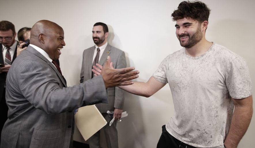 Eric Bieniemy, left, greets Washington Commanders quarterback Sam Howell, right, after being introduced as the new offensive coordinator and assistant head coach of the Commanders during an NFL football press conference in Ashburn, Va., Thursday, Feb. 23, 2023. (AP Photo/Luis M. Alvarez)
