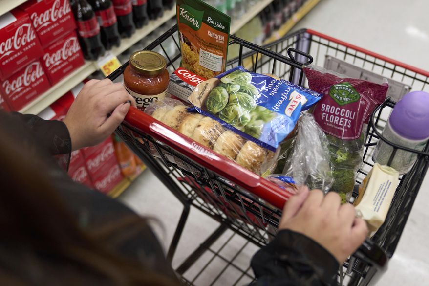 Jaqueline Benitez, who depends on California's SNAP benefits to help pay for food, shops for groceries at a supermarket in Bellflower, Calif., on Monday, Feb. 13, 2023. Nearly 30 million Americans who got extra government help with grocery bills during the pandemic will soon see that aid shrink. (AP Photo/Allison Dinner)