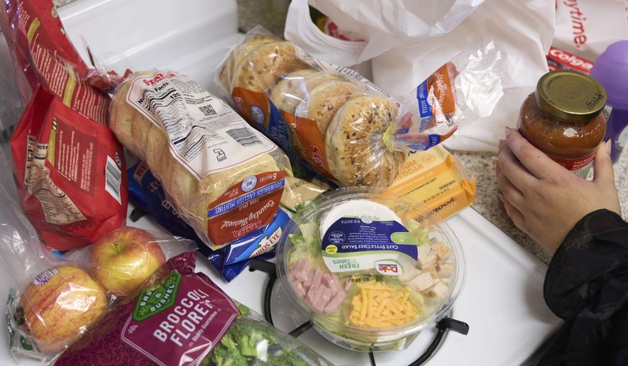 Jaqueline Benitez puts away groceries at her home in Bellflower, Calif., on Monday, Feb. 13, 2023. Benitez, 21, who works as a preschool teacher, depends on California's SNAP benefits to help pay for food, and starting in March she expects a significant cut, perhaps half, of the $250 in food benefits she has received since 2020. (AP Photo/Allison Dinner) ** FILE **