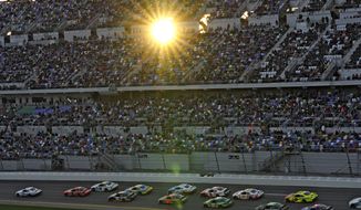 Austin Hill (21) leads the field into turn one as the sun peeks through the grandstand during the NASCAR Xfinity Series auto race Saturday, Feb. 18, 2023, at Daytona International Speedway in Daytona Beach, Fla. (AP Photo/Chris O&#x27;Meara)