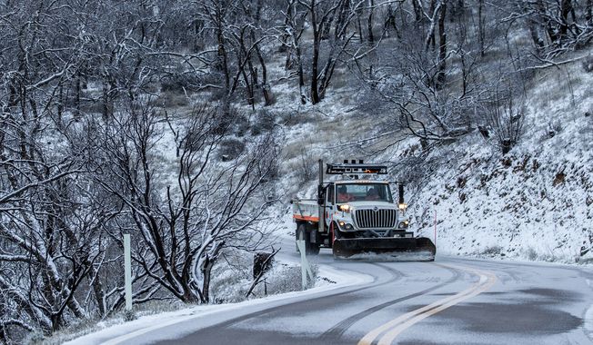 A snow plow works along Mount Hamilton Road in Unincorporated Santa Clara County, Calif. Thursday, Feb. 23, 2023. (Stephen Lam/San Francisco Chronicle via AP)