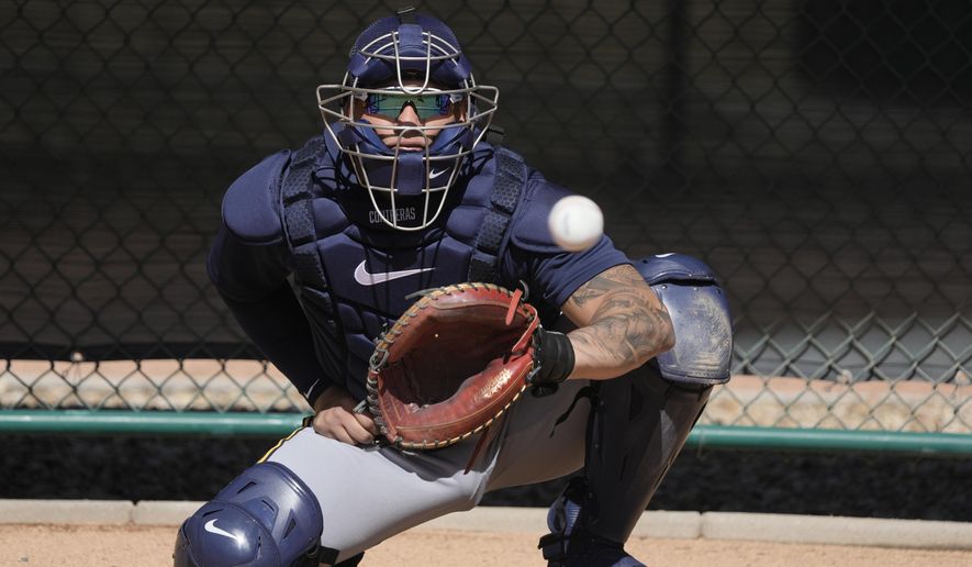 Milwaukee Brewers catcher William Contreras catches during a spring training baseball workout Thursday, Feb. 16, 2023, in Phoenix. (AP Photo/Morry Gash)