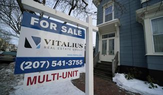 A sign announces a home for sale on Munjoy Hill, Wednesday, Jan. 25, 2023, in Portland, Maine. Over the past year, the Fed has raised its key short-term rate eight times, causing many kinds of consumer and business loans, including mortgages, to become more expensive.(AP Photo/Robert F. Bukaty)