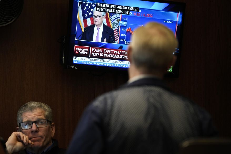 Traders on the floor at the New York Stock Exchange watch Federal Reserve Chair Jerome Powell's news conference after the Federal Reserve interest rate announcement in New York, Wednesday, Feb. 1, 2023. Over the past year, the Fed has raised its key short-term rate eight times, causing many kinds of consumer and business loans to become more expensive.(AP Photo/Seth Wenig, File)