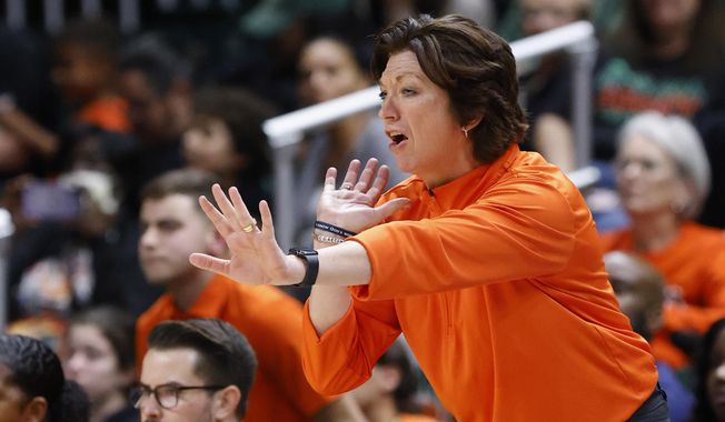 Miami head coach Katie Meier yells during the second half of an NCAA college basketball game against Notre Dame, Thursday, Dec. 29, 2022, in Coral Gables, Fla. Miami’s women’s basketball program has been placed on probation for one year, after the school and NCAA said coaches inadvertently helped arrange impermissible contact between a booster and two players before they signed with the Hurricanes. But coach Katie Meier — who already served a three-game suspension at the start of this season in anticipation of the NCAA’s decision — will not miss any more time. (AP Photo/Rhona Wise, File)