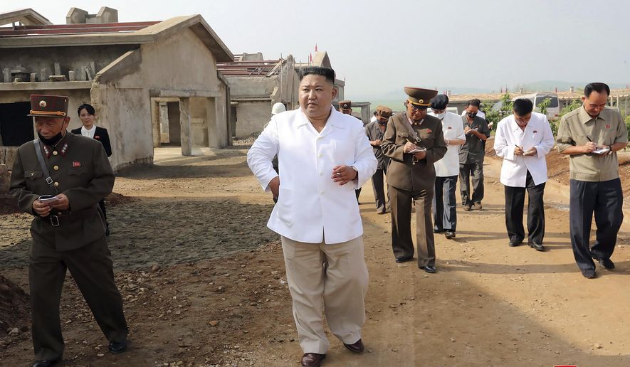 FILE - In this undated photo provided on July 23, 2020 by the North Korean government, North Korean leader Kim Jong Un, center, visits a new chicken farm being built in Hwangju County, North Korea. Independent journalists were not given access to cover the event depicted in this image distributed by the North Korean government. The content of this image is as provided and cannot be independently verified. Korean language watermark on image as provided by source reads: &quot;KCNA&quot; which is the abbreviation for Korean Central News Agency. (Korean Central News Agency/Korea News Service via AP, File)