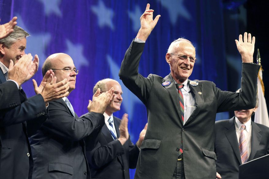 Retiring U.S. Congressman, John Olver, D-Mass., right, gestures to the audience as other members of the state's congressional delegation, including from left, John Tierney, Jim McGovern and William Keating, look on during a tribute to Olver at the Democratic State Convention in Springfield, Mass. on Saturday, June 2, 2012. Former U.S. Rep. John Olver, a Democrat who represented western Massachusetts communities for more than two decades in Congress, has died, Thursday, Feb. 23, 2023. He was 86.(AP Photo/Michael Dwyer)