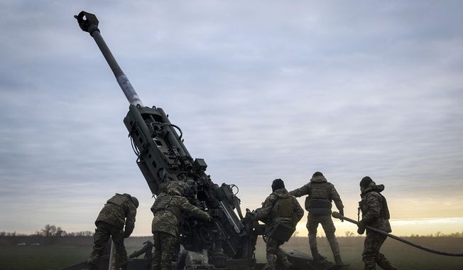 Ukrainian soldiers prepare a U.S.-supplied M777 howitzer to fire at Russian positions in Kherson region, Ukraine, Jan. 9, 2023. Quantifying the toll of Russia’s war in Ukraine remains an elusive goal a year into the conflict. Estimates of the casualties, refugees and economic fallout from the war produce an complete picture of the deaths and suffering. Precise figures may never emerge for some of the categories international organizations are attempting to track. (AP Photo/Libkos, File)