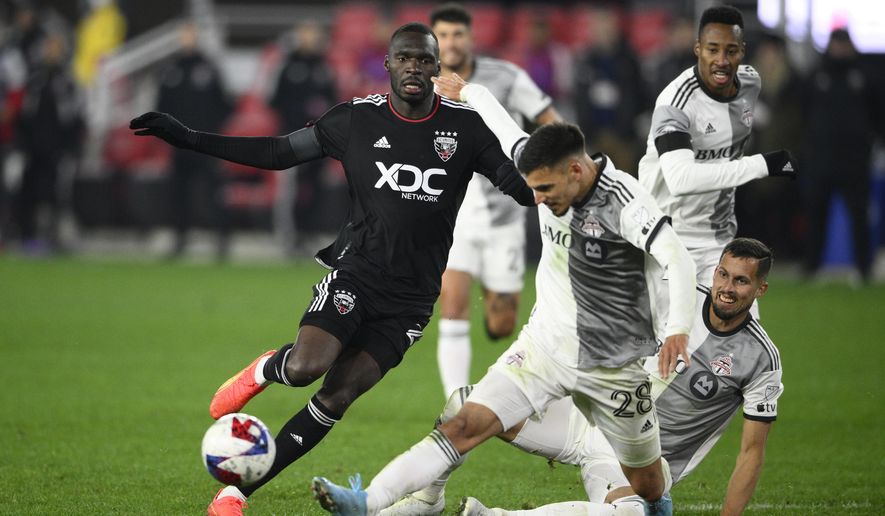 D.C. United forward Christian Benteke, left, and Toronto FC defender Raoul Petretta (28) battle for the ball during the second half of an MLS soccer match, Saturday, Feb. 25, 2023, in Washington. (AP Photo/Nick Wass) **FILE**