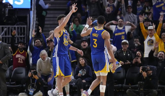 Golden State Warriors guard Jordan Poole (3) celebrates with Klay Thompson, left, after scoring a 3-point basket against the Houston Rockets during the first half of an NBA basketball game in San Francisco, Friday, Feb. 24, 2023. (AP Photo/Godofredo A. Vásquez)