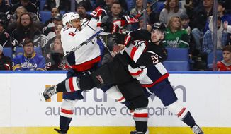 Washington Capitals left wing Alex Ovechkin (8) and Buffalo Sabres defenseman Mattias Samuelsson (23) collide during the second period of an NHL hockey game, Sunday, Feb. 26, 2023, in Buffalo, N.Y. (AP Photo/Jeffrey T. Barnes)