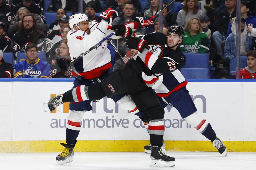 Washington Capitals left wing Alex Ovechkin (8) and Buffalo Sabres defenseman Mattias Samuelsson (23) collide during the second period of an NHL hockey game, Sunday, Feb. 26, 2023, in Buffalo, N.Y. (AP Photo/Jeffrey T. Barnes)