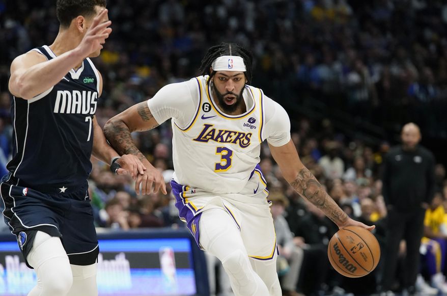 Los Angeles Lakers forward Anthony Davis (3) dribbles against Dallas Mavericks center Dwight Powell (7) during the first half of an NBA basketball game in Dallas, Sunday, Feb. 26, 2023. (AP Photo/LM Otero)