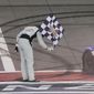 Kyle Busch takes a bow with a checkered flag after winning a NASCAR Cup Series auto race at Auto Club Speedway in Fontana, Calif., Sunday, Feb. 26, 2023. (AP Photo/Jae C. Hong)