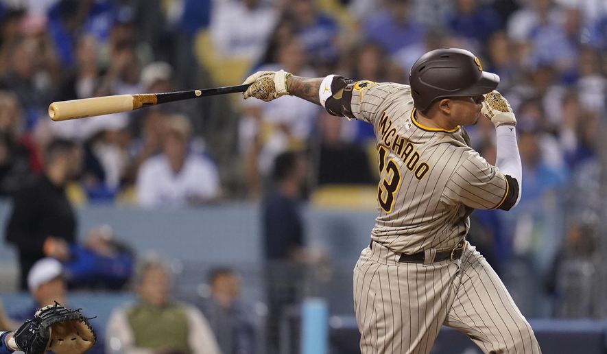 San Diego Padres&#x27; Manny Machado follows through on an RBI-double during the third inning in Game 2 of a baseball NL Division Series against the Los Angeles Dodgers, Oct. 12, 2022, in Los Angeles. Machado has agreed to a new $350 million, 11-year contract that will keep him with the San Diego Padres through 2033, according to a person with knowledge of the deal, on Sunday, Feb. 26, 2023. (AP Photo/Ashley Landis, File) **FILE**