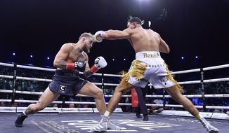 Jake Paul, left, and Tommy Fury, in action during their boxing match, in Riyadh, Saudi Arabia, early Monday, Feb. 27, 2023. (AP Photo)